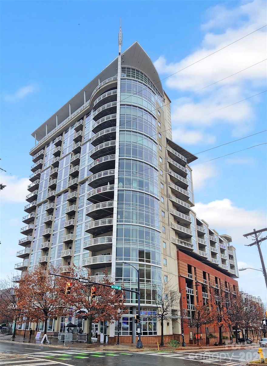Move in Ready!  INSTANT EQUITY!! Unit priced $160,000 below RECENT Sale of "like" Unit in building.  This luxury corner unit in the heart of Uptown Charlotte offers unmatched value and style. Boasting over 1,900 sq ft, the expansive open floorplan is wrapped in floor-to-ceiling windows, flooding the space with natural light and offering stunning year-round views of the Charlotte skyline. The primary bedroom also features floor to ceiling windows providing skyline views.  The OPEN layout allows you to separate spaces while still being a part of every conversation.  Unit features New wood flooring throughout, ceiling fans, walk in closets, dual vanities and huge covered patio.  Washer and dryer included. There are also 2 deeded parking spaces in the secure gated garage.  An Amazon Hub is located in garage to assure the safe delivery of packages without you being there.