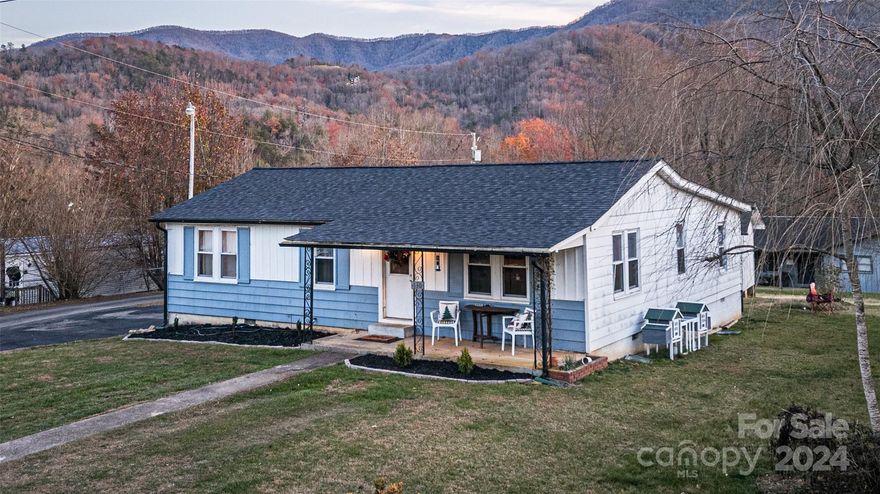 Enjoy the best of both worlds-the Tranquility of the Smokies and the convenience of in-town living in the Bryson City limits! This cozy home has so much potential! There are three bedrooms, one bath, a spacious kitchen and dining room, and a useful addition where a second bathroom could be added. The roof is new, and you will love the original wood flooring throughout! You can fix up the 2-car garage with an attached storage room! You will have plenty of room for your cars, toys, and tools! There are also multiple storage buildings on the property. If you want the reassurance of in-town living with paved access, then look no further! This will make a great first or retirement home!