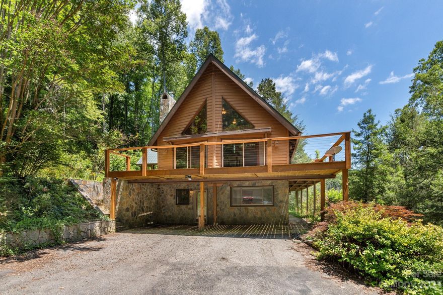 PRICED BELOW TAX VALUE! Bring your vision to this classic A-Frame on 2.5 acres connected to nearly 28,000 acres of U.S. Forest Service land. Located only 15 minutes from Marion, you will enjoy end of the road privacy surrounded by mountains with a rushing creek nearby.

This home features 2 bedrooms + a loft, and 2.5 baths. The primary bath includes an in-ground hot tub surrounded by windows offering a 180-degree view of the forest. The finished basement includes a full kitchen, bedroom with full bath, flex space usable as an office or media room, as well as a laundry/utility room. The basement has separate access, making it the perfect rental or guest space. Opposite the home you will find a large two-car detached garage with a second-story loft space.  The loft is a "blank slate" - use it for storage, a studio, or additional living space.

This home needs maintenance and repairs to achieve its full potential. The seller inherited the home and has not lived there.