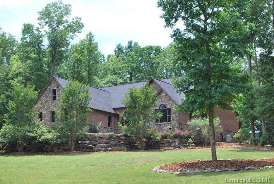 Desirable Pleasant Gardens community-Pleasant Meadows Estate-Custom Built-Quality throughout-Larger brick & rock, 4 BR, 2.5 BA home located on 1.81+/- acres near end of private dead end street.  Convenient location w-private surroundings.  Home features lots of extras including vaulted ceilings formal dining area, built in entertainment center,bookcases,fireplace,office area/study,upstairs bonus playroom area,oversized 2 car garage,living room & den.  Home also features larger rooms throughout w-large master suite w-walk-in closets,large glamour bath s-garden tub,separate glass & ceramic show,custom tile & large granite vanity ,large kitchen w-custom cheery painters,island, bar, stainless steel appliances,large pantry closet,granite counter tops. Also include a detached 1 car garage w-workshop, custom large rock work in yard.