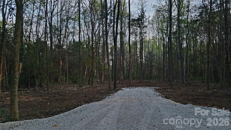 Don't miss your chance to own this hard to find acreage within the City of Concord. This 3 acre tract is a rare find if you are looking for land that offers the convenience of proximity to shops and restaurants, but still enough space to create your very own private oasis to build your dream home! Located on a small private road, just off of Rock Hill Church Rd. There is no HOA, no timeframe to build, and bring your own builder. City sewer is available and the tap fee will be paid by the seller. A well will be needed. The well permit has been applied for, and runs with the land. Some of the trees and underbrush have been cleared, and a gravel drive put in place. The recently built West Cabarrus High School is within 1.9 miles, and the Cabarrus Country Club is only a mile away. Also, Afton Ridge & I-85 (3.4 mi), Frank Liske Park (6.7 mi), Concord Mills (8 mi), and Bank of America Stadium is only 23 miles away. This listing is for a total of 3 acres, currently broken down into 4 parcels, we are in the process of recombining the lots, which will be completed prior to closing. Agent owned.