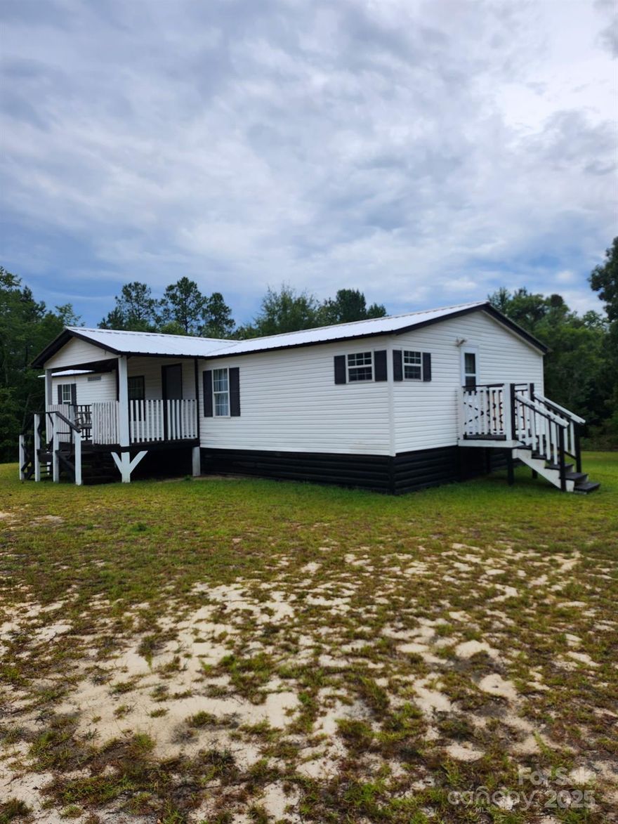 Charming Country Home – Peaceful, Private & Move-In Ready!
Back on the market through no fault of the sellers! Welcome to your slice of country paradise. Nestled on a quiet road, this 3-bedroom, 2-bath home sits on an acre with a private backyard, mature trees, and space to breathe, dream, and play.

Freshly painted inside, the home feels light, bright, and welcoming. A new metal roof adds peace of mind, while the cozy living area flows into a sunny dining space and kitchen. The primary suite offers a peaceful retreat with a walk-in closet, and the second bathroom includes a large soaking tub—perfect for unwinding.

Enjoy slow mornings on the front porch swing and peaceful evenings on the back deck, surrounded by the charm of country living. With inspections already complete, this home is ready for a smooth closing. Don’t miss your chance to make it yours—schedule your showing today!