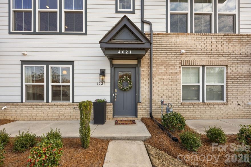 Welcome to this stylish three-bedroom townhome offering a thoughtful layout, beautiful natural light, and inviting indoor and outdoor living spaces! 

The first floor features a private office and convenient half bath, creating a perfect setup for working from home or a flexible bonus space. Upstairs, the main living area is filled with natural light, with morning sun streaming into the living room—an especially welcome feature in this interior unit.

The spacious kitchen is designed for both everyday living and entertaining, featuring a huge center island, stainless steel appliances, a stunning tile backsplash, and abundant cabinet storage. Just off the dining area, a charming coffee bar creates the perfect spot to start your day or host guests.

The generously sized primary suite offers a relaxing retreat, complete with a custom walk-in closet system designed to maximize storage and organization. The en-suite bath includes dual vanity sinks and a sleek glass walk-in shower. Two additional bedrooms provide comfortable space for guests, hobbies, or additional office needs.

One of the standout features of the home is the rooftop patio—an incredible outdoor space ideal for relaxing, entertaining, or enjoying evening sunsets. Ideally located with convenient access to shopping, dining, and everyday amenities, this townhome combines comfort, style, and functionality in a highly desirable setting!