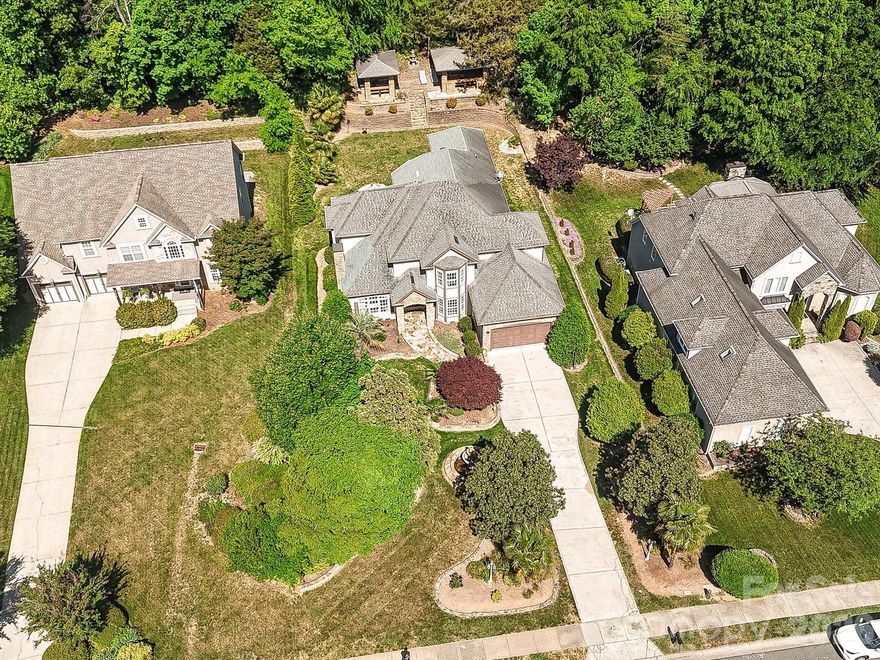 Welcome to your ultimate entertainment oasis! Nestled in the highly sought-after Crown Harbor community of Cornelius, this meticulously upgraded 4-bedroom, 4.5-bathroom luxury home offers over 4,100 square feet of pristine living space. Priced at $1,000,000, this stunning property represents an absolute rare value for the location and level of high-end finishes.

Step inside to discover a bright, open floorplan adorned with custom built-ins, elegant flooring, and a dedicated wet bar perfect for hosting. The heart of the home is the expansive chef's kitchen, featuring a massive island, gorgeous cabinetry, and top-of-the-line Thermador stainless steel appliances, perfectly complemented by built-in beverage and wine refrigerators.

The true showstopper is the backyard—a private, resort-style haven designed for year-round enjoyment. Entertain guests effortlessly on the spacious deck, gather around the cozy outdoor fireplace on crisp Carolina evenings, or relax under the veranda and charming gazebo. The large, flat yard is a rare find, featuring pristine landscaping, in-ground irrigation, and serene water views of the lake.

Complete with access to excellent community lake amenities including a boat ramp and dock, this masterpiece perfectly blends luxury, comfort, and the ultimate Lake Norman lifestyle. Don't miss this incredible deal—schedule your showing today!