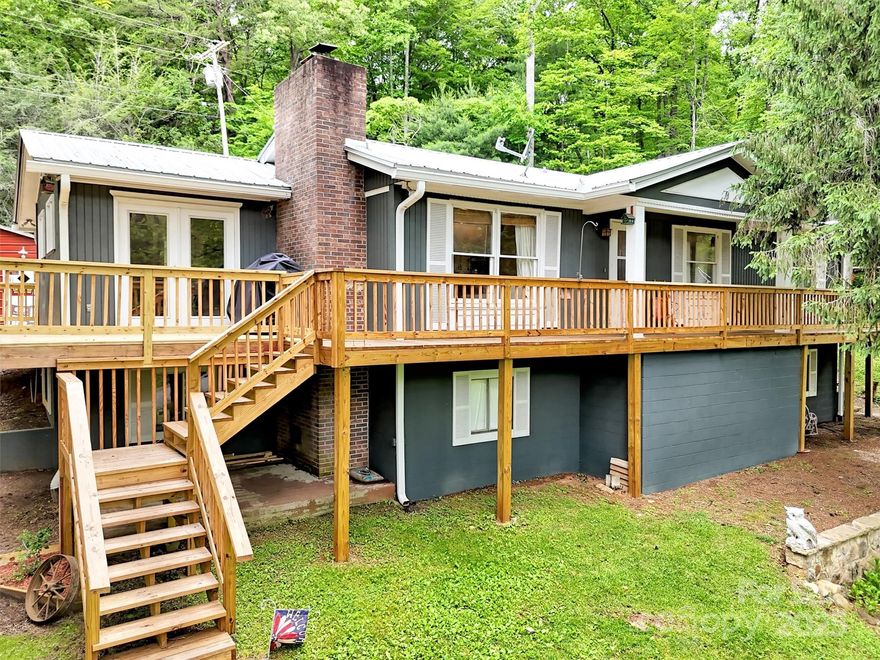 WOW!  $25,000 PRICE REDUCTION!  SELLERS SAY BRING YOUR OFFER, THEY ARE MOTIVATED! Nestled in the scenic beauty of Western North Carolina, this 3 bedroom, 3 bath renovated home in Baird's Cove offers the perfect blend of comfort, space and natural serenity.  Situated on a sprawling 1.5 acre lot this property is a rare gem, ideal for those seeking a peaceful retreat with the modern conveniences of Franklin only minutes away.  This home boasts 2 bedrooms and 2 full baths on the main level with a large kitchen and living room and separate dining room.  The main level features a wrap around deck providing access to the expansive back yard, and metal workshop building. The expansive, fully finished basement adds versatile living space -- perfect for a recreation room, home theater gym or additional living quarters with a nice sized bedroom and full bath.  Walk out to the fabulous front yard for gardening, simply enjoying the tranquility of your surroundings.  Call today!
