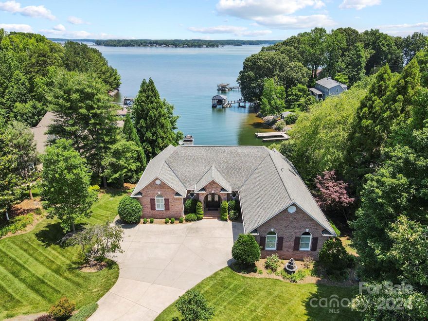 Live with picturesque water views every day in this wonderful waterfront ranch home on Lake Norman's west side! With natural light and views from every room, this home features a bright, open floor plan with vaulted ceilings and the opportunity to enjoy yourself indoors and out. The primary bedroom with large spa-like ensuite with jacuzzi tub is on the main level, along with a powder room, large living room, dining room, and well appointed eat-in kitchen with access to the upper balcony. The lower level features a completely separate living area with two bedroom suites, a room with double bunk beds, a living room, bar, and office. All lower level rooms have lake views as well and access to the lake level terrace, hot tub, and fireplace. The private dock on a deep, quiet cove provides easy access for lake swimming, kayaking, fishing & boating. This home is being offered fully furnished with the hot tub included (exercise bike excluded).