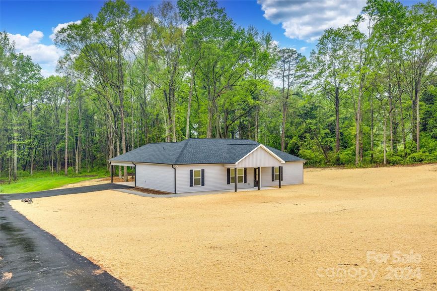 Brand New Construction on 2 Acres! Don't miss out on seeing the exceptional quality this property offers, with granite countertops in the kitchen and all bathrooms. Throughout the entire home, you'll find luxury vinyl plank flooring, except for the tiled floors in the primary bathroom, which boasts a walk-in tiled shower with a frameless glass door. The primary bedroom and living room feature 9-foot ceilings with crown molding for added elegance. The kitchen is equipped with stainless steel appliances, a dine-at island, custom cabinets with soft close doors and drawers, and a tiled backsplash. Each of the 3 bedrooms includes a walk-in closet. For added convenience, the laundry/mud room is situated at the rear entryway. Step outside to enjoy the covered rocking chair front porch, the large attached rear carport, perfect for parking and entertaining, and a rear concrete patio. The wooded backyard offers privacy, shade, and a peaceful view of birds and wildlife. Low SC taxes! No steps!