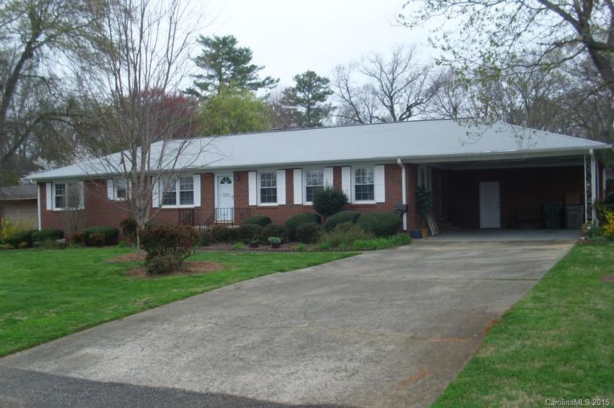 Must see to appreciate, 4 Bedroom, brick house with Living Room/Dining Room combination, Den with fireplace, Sunroom with Deck, 2 Car Carport. All ceiling fans, curtains in 3 bedrooms, refrigerator, range all to convey.  .
