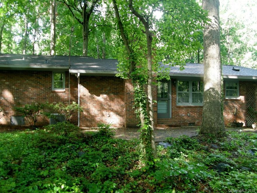 3BR 2.5BA Brick home with great potential sits on a .79AC wooded lot. Living room, formal dining room and a den/kitchen combination. Den has a brick fireplace with gas logs. Attached 2 car garage & large 12x16 detached shed/workshop with power, window unit A/C, intercom and phone service. Very private backyard with natural surroundings.