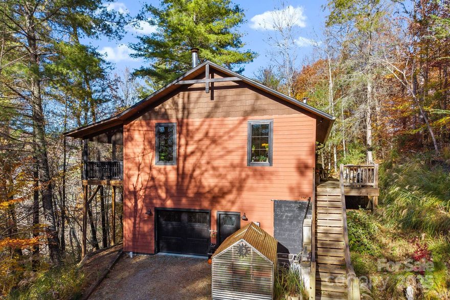 Are you ready for your own private luxury getaway tucked into the trees? Then come see this elegant, light-filled cabin in the woods! This contemporary build features soaring ceilings, walls of windows, gleaming counters and appliances and everything you need for a modern lifestyle without the modern stress! Relax in the hot tub, rock the day away on the hammock on the huge screened deck listening to the breeze and the birds, celebrate with family and friends in the welcoming gathering spaces around the fire! Thoughtful floor plan takes every need into account offering open spaces, peaceful bedrooms, lovely bathrooms, downstairs guest quarters, and a large garage; wide screened deck accommodates all of your social and relaxing activities! All of this peace and beauty is yours while still being only 25 minutes to Downtown Asheville and all of the pretty towns in-between!