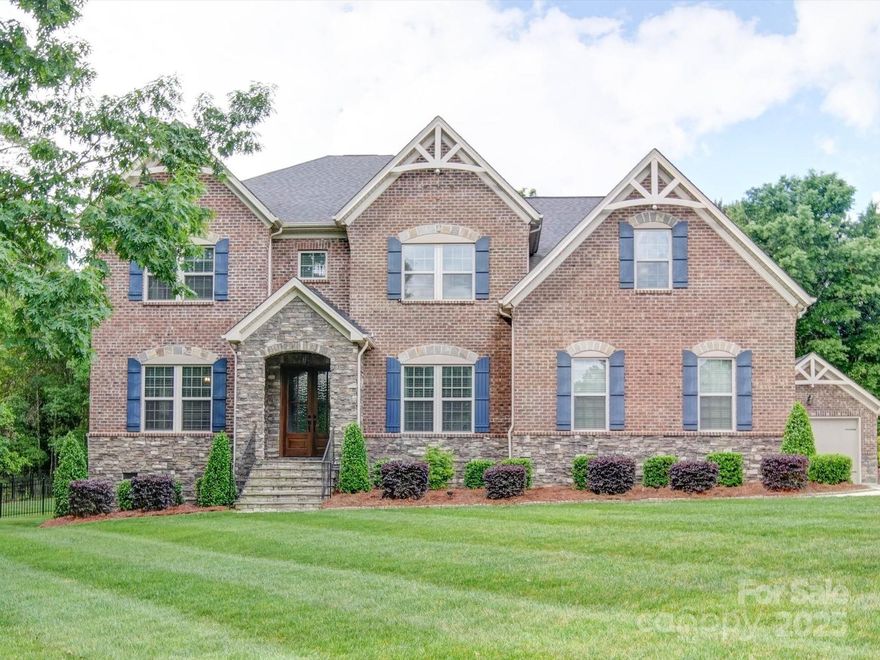 Stunning full Brick home with stone accents located on over a 1 acre homesite, backing up to trees for additional privacy! This home truly shows like a brand new model home & features beautiful extensive moldings & tray ceilings and so many interior designer upgrades. The open concept kitchen & butlers pantry feature white cabinetry, white quartz counters, gas range, farmhouse sink & custom adjustable lighting. Living rm with modern fireplace. The covered back porch & extended deck (trex decking) overlooking the very private backyard are perfect for all your outdoor living needs. First floor guest suite, dining, dual staircases, study w/french doors & backdoor drop zone complete the main floor. Upstairs owners's suite customized w/sitting area & fireplace huge bonus, 3 large secondary beds and attic storage. 3 Car garage w/extra rm for storage & added detached one car garage with double garage doors. Top rated Weddington schools! Gated community, pool, tennis courts, clubhouse, & pond.