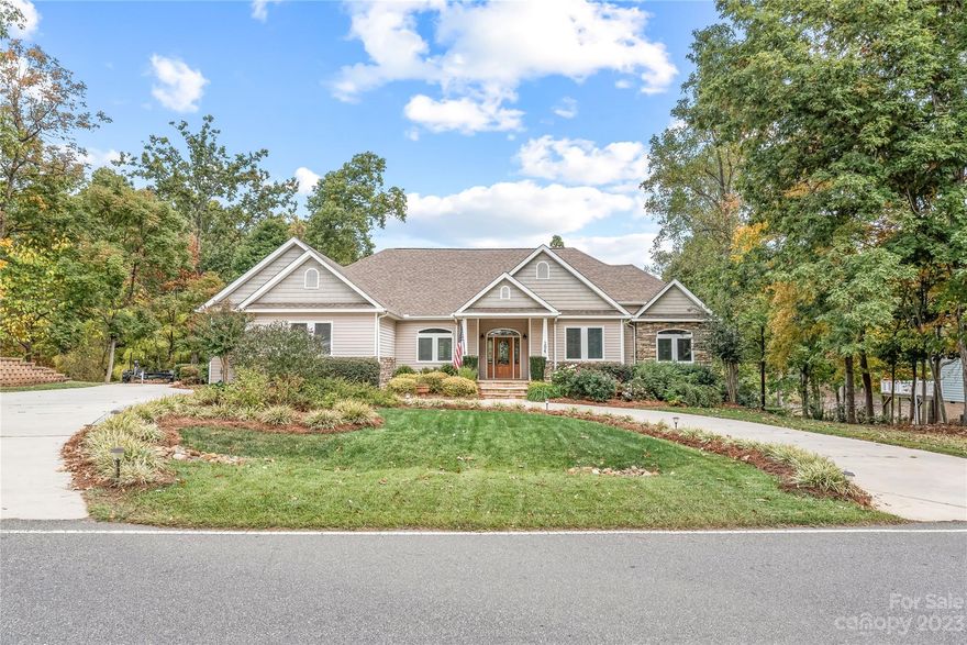 A rare opportunity to own a lakefront property that exemplifies perfection, where you can relish in the beauty of the water and the luxurious upgrades all around. This gem is nestled on a gently sloped lot with 85ft of waterfront that offers gorgeous views and deep water year round. Step inside where you will be wowed by the expansive water views, abundant natural light with floor to ceiling windows, and an inviting open floor plan. The kitchen offers copious amounts of storage and counterspace complete with granite and recessed lighting. Primary suite is a true retreat with a sitting area, two walk-in closets, garden tub, and tiled shower. Discover the endless possibilities in the finished basement, where you will find secondary living quarters with a kitchen, full bath, and office/potential bedroom. The outdoor living area offers a fireplace, covered patio, new waterside patio, and deck with new Trex decking. Floating dock with new boat lift, new covered structure, and pier!