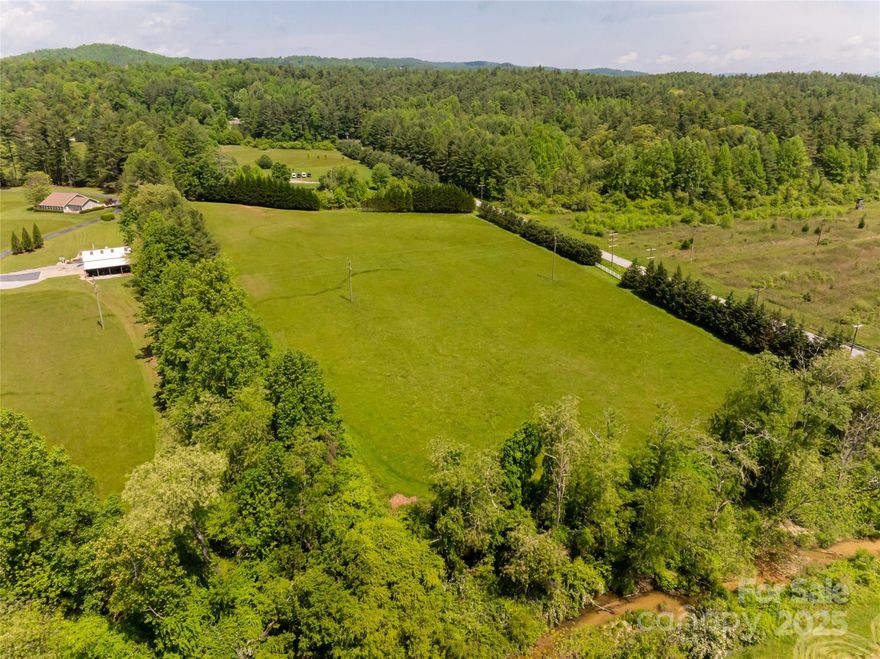 Nestled in the stunning landscape of western North Carolina, this expansive almost 8-acre parcel offers a rare opportunity to own a level expanse of land with mountain views. The property is characterized by its gentle topography, providing an ideal setting for a dream home. As you stand on this beautiful land, you’ll be greeted by panoramic vistas of the surrounding Pinnacle Mountain, their majestic peaks rising in the distance. The level terrain makes it easy to envision various uses for the property, whether it’s building a spacious residence with large windows to capture the scenic beauty, creating a serene garden oasis, or designing a family-friendly outdoor space for gatherings and activities. The land is adorned with trees and open space, inviting wildlife and providing a tranquil atmosphere. With easy access to nearby hiking trails, lakes, and charming downtown Hendersonville and Brevard, this location offers both seclusion and convenience.