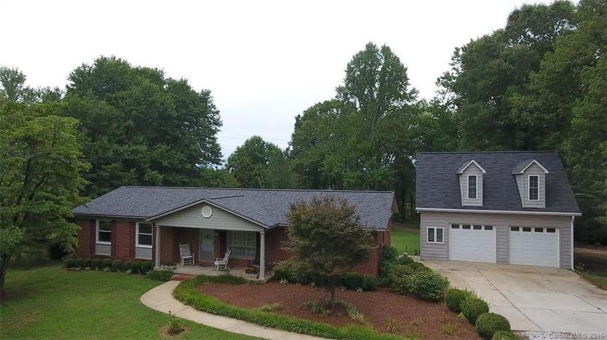 3 BR 1-1/2 Brick Ranch on quiet, wooded 2.7 acres. Hardwood floors through main house, vinyl in kitchen, tile in bathrooms.  Roof replaced 2014. Oversized 2 car detached garage (23 x 28) with bonus room upstairs and large shed roof off the back. Nice flat lot with lots of trees and no adjacent neighbors.  1 year Home Buyers Warranty provided by the seller.  If you like privacy this is for you.