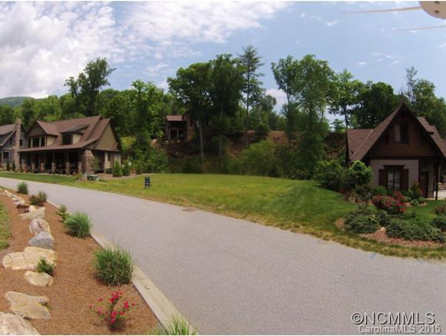 Just a stone's throw from water's edge of Lake Lure, offering a level, ready to build site. Creek frontage on  rear of property sets the stage for an idyllic vacation home or your permanent residence. All Firefly Cove amenities available in this private, gated enclave. Views of Lake Lure and surrounding mountains are never ending. Come home to the filming location of Dirty Dancing!!!