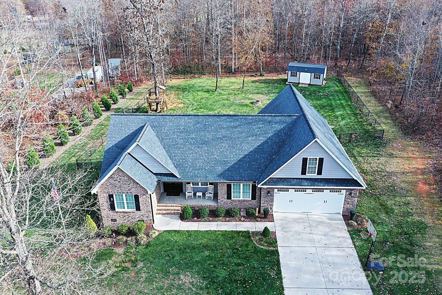 This charming 3Bed/2Bath home is move-in ready and situated on nearly an acre in a peaceful subdivision just off Hwy 16.While conveniently close to major interstates and 40 minutes from Charlotte Douglas International Airport, it offers a serene, rural atmosphere. This location is perfect for someone with a desire for open space but close to Charlotte and Hickory. The property boasts excellent curb appeal, welcoming you from the moment you arrive. Upon entering through the covered front porch, you are greeted by a spacious living room featuring coffered ceiling and a gas fireplace. The lovely kitchen is equipped with custom cabinetry, blackened steel appliances, oven with warmer, and granite countertops, and breakfast bar, making it a delightful space for cooking and entertaining. Adjacent to the kitchen is a formal dining room, ideal for hosting guests. The extraordinary primary bedroom, located on the main level, includes an expansive walk-in closet and a luxurious bathroom with separate vanities, a makeup counter, a water closet, and a stunning walk-in shower. Upstairs, the home offers versatile space with a large bonus room. The level, fenced-in backyard is perfect for outdoor activities and includes a storage building, firepit, treehouse, and added privacy from the surrounding woods, along with an additional lot for extra space. This home is a must-see!