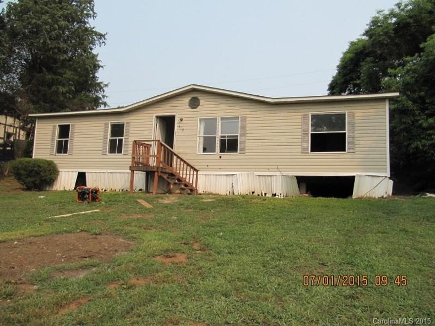 Three bedroom two bath doublewide mobile home in need of repair.  Carpet has been removed.