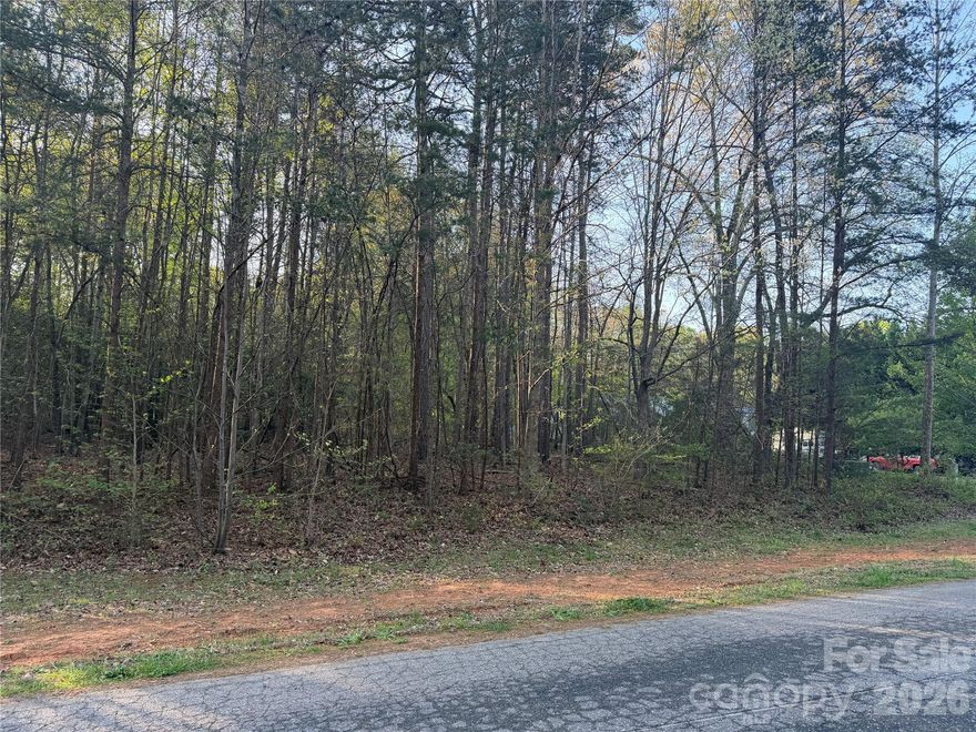 Private, picturesque wooded lot .69 acres at 1270 Forest Ridge Drive, Bessemer City — build your dream home among mature hardwoods and tranquil surroundings. This rare offering can be bought with an adjacent plat and the home on the middle property will be for sale in the near future. This property provides flexibility for expansion, privacy buffers, or future resale. Conveniently connected to the public road with easy access, gentle topography, and a canopy of established trees that create a serene, park-like setting. Ideal for buyers seeking country-feel living close to town.