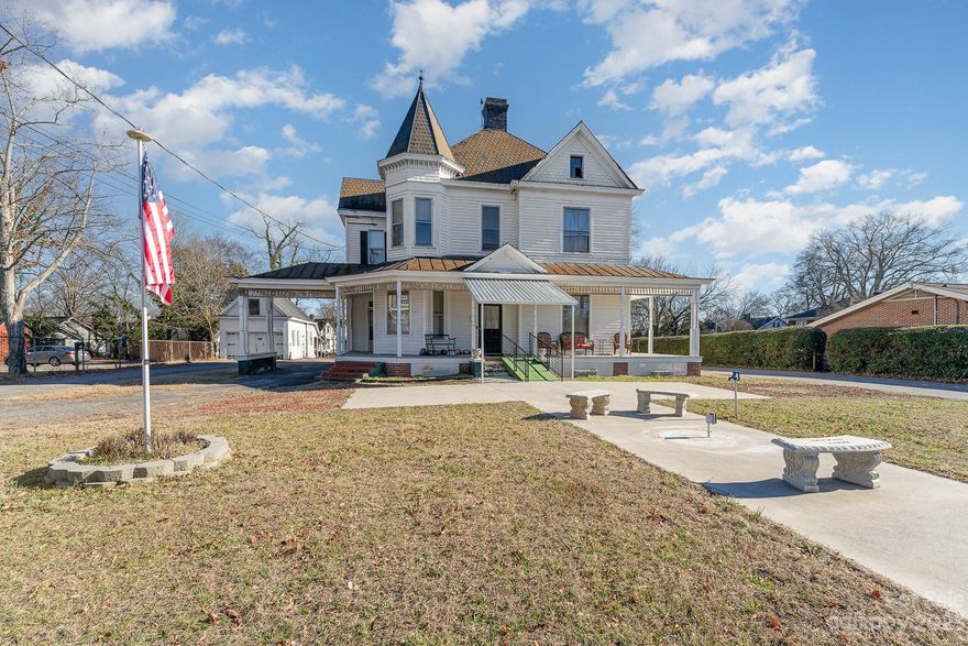 Situated in the heart of Statesville, this 1900s Queen Anne home in the Historic District invites you to relive the gilded age. With 4 beds, 2 baths, and captivating features such as massive ornate fireplaces, hardwood floors, ceilings over 11ft+ tall, the grand foyer, pocket doors, and many original fixtures, this gem exudes historic charm. The 2-story layout includes a 3rd-floor walk-up attic and an amazing attic loft. State rooms, living rooms, and more – this home epitomizes historic elegance. Upstairs has no cooling.Original carriage house serves as a garage with an upstairs blank slate, once an apartment. A full renovation is needed; must be cash or renovation loan. Contact the list agent for comprehensive disclosures and discover the countless features that make this home extraordinary.