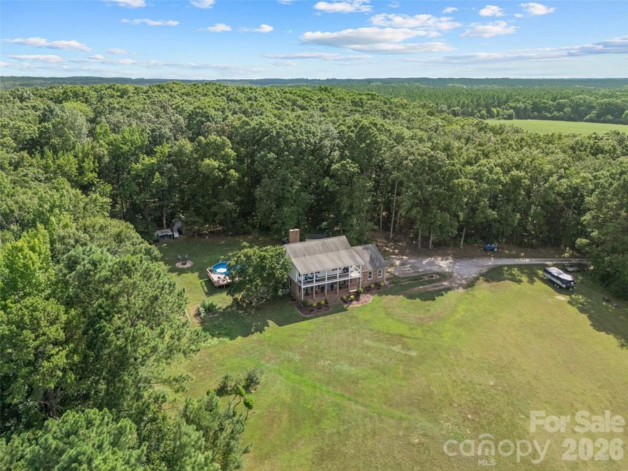 **Motivated Seller** Tucked away on 15.68 private acres, this custom-built home offers the kind of peaceful country living that’s getting harder and harder to find. With 4 bedrooms, 2.5 bathrooms, and a thoughtfully designed layout full of character, this property blends warmth, functionality, and space both inside and out. Step inside to soaring 9-foot ceilings, rich hardwood floors, exposed wood beams, and a stunning wood-burning fireplace with custom built-ins that creates the perfect centerpiece for the living room. The kitchen was designed with both everyday living and entertaining in mind, featuring granite countertops, an eat-in breakfast area, and an easy flow into the formal dining room for gatherings with family and friends. A separate sitting room offers additional flexibility for a den, playroom or second living area. The converted garage space adds even more versatility and could function as a home gym, media room, oversized bonus room, or future primary suite conversion with existing storage already in place that could be converted into a full bath and closet. The primary suite feels like its own private retreat with a soaking tub, walk-in shower, and double vanity, while the updated bathrooms throughout the home add modern touches without losing the home’s timeless charm. Outside is where this property truly shines. Whether you dream of starting a mini farm, bringing animals, riding ATVs, gardening, building additional outdoor entertaining spaces, or simply enjoying the privacy and beauty of acreage living, this property gives you the freedom to create the lifestyle you want. Cool off in the above-ground pool, enjoy quiet evenings under the stars, and take in the endless possibilities this land has to offer. If you’ve been searching for acreage, privacy, and a home with character and flexibility, this one is truly a rare find. **Seller is entertaining all offers and offering a home warranty for additional peace of mind**