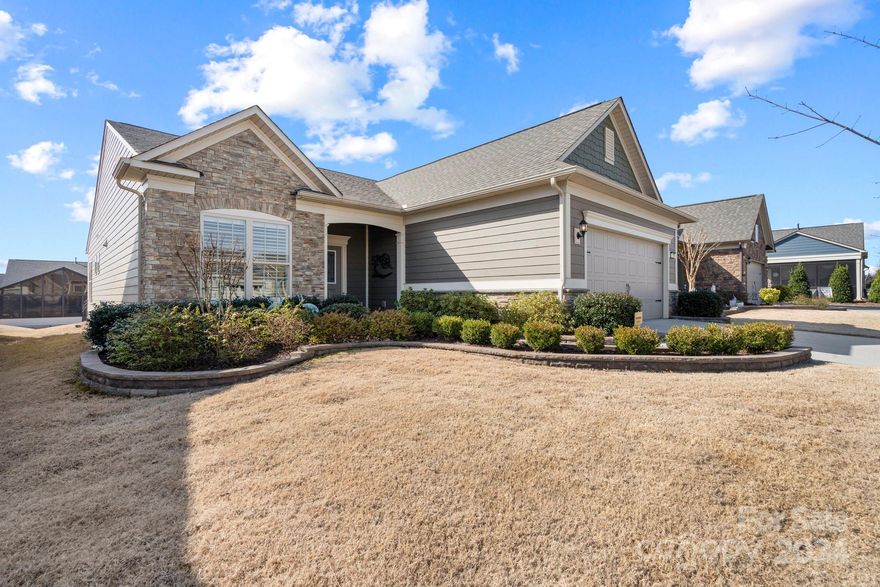 Beautiful Castle Rock model.  Upgraded Kit includes quartz counters, gas cooktop, direct vent hood, KitchenAid appliances-refrigerator inc, under cab lighting, pendant lights over island, cab conv pkg w/pull out drawers. Open floor plan - great for entertaining. Shutters. Fireplace w/blower in Great rm. Sunroom. Primary BR w/tray ceiling & fan, primary bath w/roll-in shower w/rainfall shower head, double sinks & vanity area, walk-in primary closet. Laundry rm w/cab, includes washer/dryer. Drop zone leads to Gar w/utility sink, built-in cabs, finished floor. Screened Porch leads to patio, gas line for grill, fenced yard, irrigation system, professional landscaping. Amenities include: indoor/outdoor pools & hot tubs, clubhouse, fitness center, ballroom, meeting rms, playground, dog park, 8 lit pickleball cts, 4 lit tennis cts, bocce cts, aerobics rm, full-time activities director w/lots of activities & clubs to choose from. Come join is in the Orchards. It's a great place to call home!