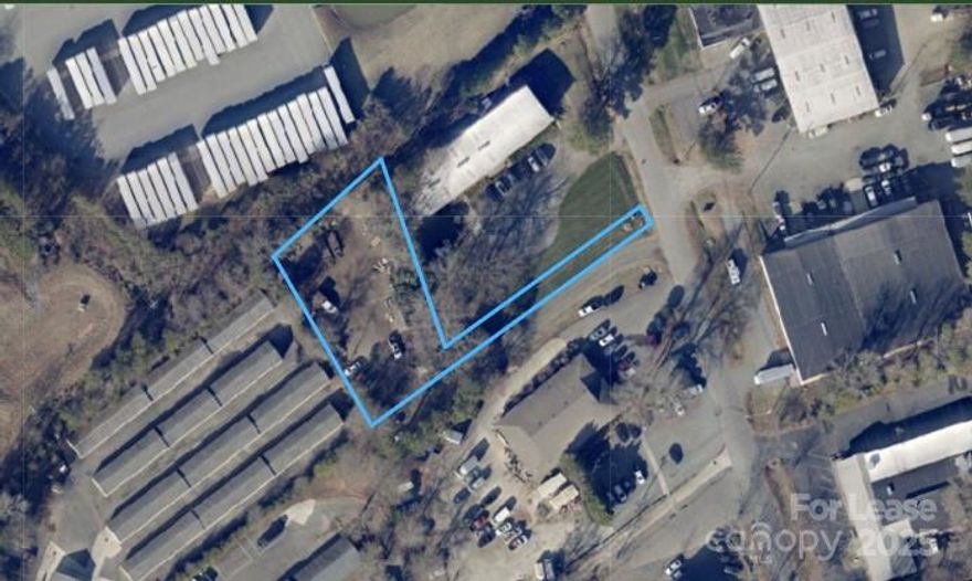 Unimproved .50 acre light Industrial dump yard in the heart of Matthews. 8 bay pole barn vehicle ports, along with brand new 320 sq ft pop up manufactured office/outbuilding with power.