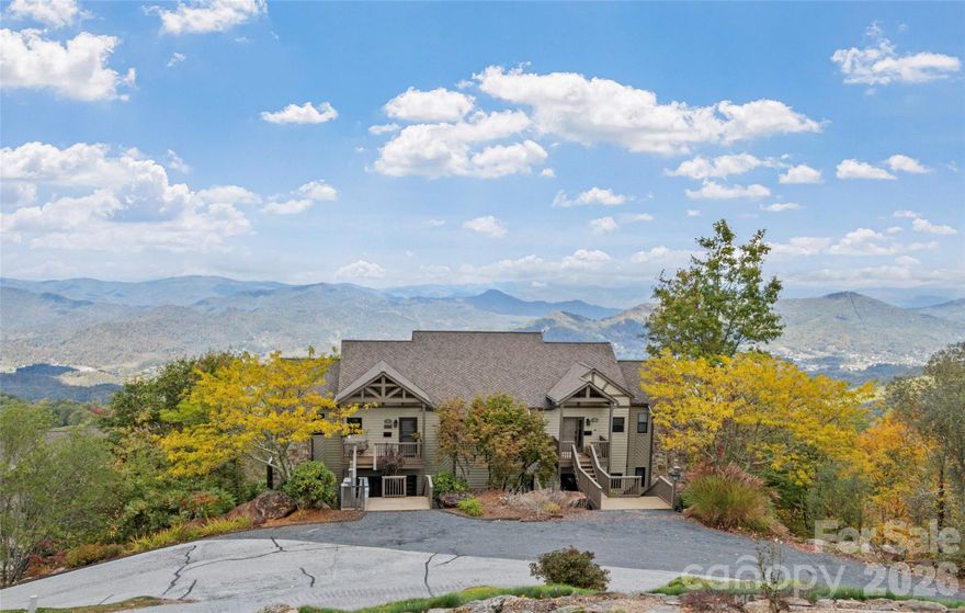 WOW. This 2BR, 2BA Club Villa Condo at the top of MOUNTAIN AIR offers a great blend of comfort, charm, and unbeatable views. Just steps from the Wellness Center and within easy walking or golf cart distance to the club's full suite of amenities, the location is as convenient as it is scenic. With just over 1,000 square feet, the downstairs layout feels open and spacious thanks to a thoughtful floor plan and a wall of windows that capture sweeping, western-facing views of the mountains and valley below. The kitchen is well-equipped with stainless steel appliances, plenty of cabinet storage, and a beautiful backsplash that adds a stylish touch. Both bedrooms are en suite, giving you flexibility for guests or your own private retreat. One of the best features of this condo is the presence of not one but two view decks—accessible from both bedrooms and the main living area—perfect for watching sunsets, meteor showers, storms, or stargazing under clear mountain skies. The home’s interior has that warm mountain feel with knotty pine ceilings and trim, rich hardwood floors, a floor-to-ceiling stone fireplace with gas logs, and built-in shelving that adds both charm and functionality. The living space also includes a smart thermostat you can control from your phone, adding a modern convenience to this mountain hideaway. While the condo will be sold mostly unfurnished, some quality items will convey with the sale, including a washable Ruggable living room rug, a Vizio TV, and all dishes in the glass-front cabinets. Be sure to check the exclusions list for complete details. You’re not just buying a condo here—you’re stepping into a lifestyle. Hawk's Ledge Park is just up the hill, and as a Mountain Air resident, you’ll have access to seven private parks and more than six miles of hiking trails. For aviators, the community even features the highest private runway east of the Mississippi, making it easy to fly in and walk to your door. Club amenities such as the 18-hole golf course, racquet sports, spa, dining, and more are available through a separate membership. This mountain retreat offers a cozy, character-filled space in one of the most sought-after locations within Mountain Air. With views like these and this kind of proximity to everything, at this price, it’s not likely to stay available for long.