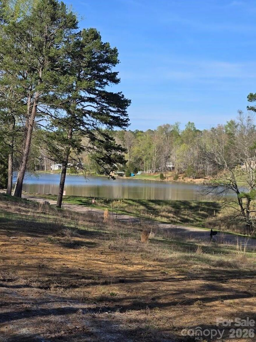 .92 Acres with over looking Lake Lynn.  Cleared lot with driveway pipe in place. Improvement permit on file with county for 3 bedroom septic system.  Minutes from 49, 601, historic downtown and Cabarrus Arena.