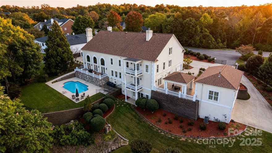 Discover lakefront luxury redefined at this extraordinary custom estate in Hickory’s exclusive Governor’s Harbour community. Perfectly positioned on 1.77 acres of prime Lake Hickory waterfront, this gated property offers an unmatched combination of timeless European architecture, panoramic lake and mountain views, and resort-style amenities. Built with enduring craftsmanship and designed for both grandeur and comfort, this nearly 10,000 sq ft residence showcases intricate architectural detail and quality finishes throughout. The main level welcomes you with a sweeping two-story marble foyer, curved staircase, and a dramatic great room with soaring ceilings and expansive windows framing the lake. Entertain in the elegant formal dining room, billiards room, and sun-filled gourmet kitchen—complete with professional-grade appliances, custom cabinetry, and a spacious breakfast area overlooking the water. The private owner’s wing is a true retreat, featuring a sitting room with wet bar, a spa-inspired bath, and an expansive 1,700 square foot owner’s suite with private balcony overlooking the lake, offering a serene vantage point for sunrise coffee or evening sunsets. Each of the home’s additional bedrooms includes its own en-suite bath, ensuring privacy and comfort for family and guests alike. The walk-out lower level offers a recreation room, office, guest suite, and direct access to the pool terrace—ideal for entertaining. Outdoor living is elevated with a heated in-ground pool, terrace with stone patio and professionally landscaped grounds illuminated by landscape lighting. A path leads to your private covered dock equipped with a boat lift and personal watercraft lift, offering direct access to Lake Hickory’s main channel. Recent updates include a new roof installed in 2025 and replacement of all six HVAC units in November 2023, ensuring long-term comfort and efficiency. Completing the estate is a separate guest house, fully equipped with its own kitchen, living room, bedroom, and four-car garage—providing flexible options for multi-generational living, guests, or private workspace. Combined, the property offers parking for six or more vehicles, with a circular drive and side-load garages. Additional features include multiple fireplaces, surround sound, a whole-house security and surveillance system, in-ground irrigation, fenced backyard, and zoned heating and cooling for year-round comfort. City water and sewer. Governor’s Harbour is a premier gated lakefront community in Hickory—minutes from downtown amenities, schools, and restaurants—yet offering the tranquility of a private lakeside retreat. This architectural masterpiece combines elegance, livability, and unforgettable views. Experience lakefront living at its finest—schedule your private showing today.