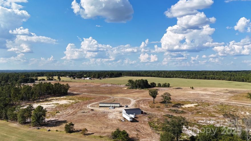 LOOKING FOR ACREAGE W/ A HOME???  Look no further! This 83.90-acre tract of land w/ planted pines on approximately 20 acres, with a 2020 Flintwood 16X76 (1216 sq ft) mobile home w/ 3 bedr / 2 ba. is just might be what you are looking for!  The 2 bay, 30x50 shop, fully wired, insulated & heated, on property adds to the 'beauty' of this 'FIND'!  The property hasn't got a pond BUT property borders a stream.  Also, a possibility of a 'wet weather pond' is also an option.  Call me or your Realtor and LETS TAKE A LOOK & 'make a deal'!!