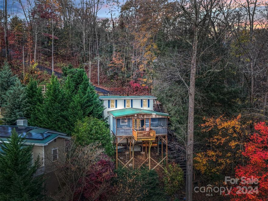 This delightfully updated 1950s cottage offers prime lakefront living on Lake Lure. Located in Tryon Bay, a large protected “no-wake” zone, complete with a private dock and ample space for your boat & water toys. Perfect for entertaining, the home boasts expansive decks and a spacious screened porch that provides stunning lake views. A generous parking area accommodates multiple vehicles. Inside, the home features a blend of hardwood floors, tile, and charming wainscoting, creating a cozy yet open atmosphere. Stylish finishes throughout, add to the home's timeless appeal. Convenient location and close to everything. Make an appointment today to see what makes this such a special place on Lake Lure!