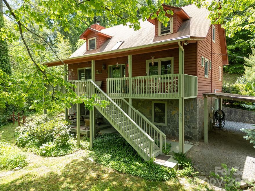 Tucked into the Cataloochee Heights area of Waynesville, 31 Valley Cove Place offers the ease of year-round mountain living with the character, warmth, and flexibility buyers hope to find in a true mountain home. The main residence features all main-level living with 2 bedrooms, 2 baths, wood and tile floors, a beautiful stone fireplace, leathered granite countertops, pantry storage, Miele appliances and striking wood posts that give the home an inviting, crafted feel. The upper level offers an open loft, bedroom and full bath creating flexibility for either level to serve beautifully as a primary suite.

Thoughtful updates include a new roof and HVAC in 2024. Layers of covered decks extend the living space outdoors, overlooking a gorgeous yard with mature plantings, raised garden beds, greenhouse and a creek along the property border. The separate 762-square-foot apartment includes a full kitchen and bath with its own exterior access—ideal for guests, extended family, work-from-home space or added flexibility for second-home use.

Driveway access is available on both levels, making daily living, unloading, and apartment access especially convenient. Located near Cataloochee Valley, with evening elk sightings in nearby fields, this property offers a wonderful blend of privacy, beauty, access, and mountain charm. Offered fully furnished with hard furnishings including many beautiful antiques. A rare offering where thoughtful updates, flexible living spaces, garden beauty, and the quiet magic of Cataloochee come together in one deeply inviting mountain property.