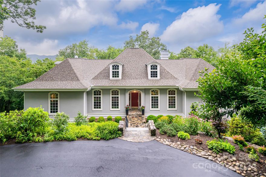 Set on over 6 acres with year-round, panoramic views, 1169 Town Mountain is just 9 minutes from downtown Asheville and 5 minutes from the Blue Ridge Parkway. Carefully curated landscaping welcomes guests with an elegant and gentle approach to the home. Enjoy one level living with the renovated kitchen, common living space, and all 4 bedrooms on the main level. Custom ceiling detail in nearly every room! The primary suite features intricate moldings, tray + vaulted ceiling, gas fireplace, double vanities, jacuzzi tub, tile shower, and two walk-in closets. In the basement a large family room includes a wet bar, gas fireplace, and half bath as well as a full workshop and large, unfinished space which is perfect for storage or future expansion. The oversized 3-car garage is heated with an epoxy floor. Incredible outdoor living space with two decks to take in the mountain vistas at over 3000 ft in elevation. Whole house generator installed in 2022. No short term rental restrictions found.