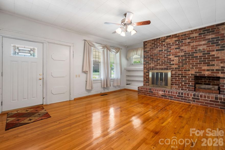 All new flooring in 4 ROOMS, plus a Price Reduction and $15,000 Seller Credit for further Updates! A rare opportunity to own one of Maiden's most charming and solidly-built Craftsman Bungalows.  With 4 BR and 2 full baths, this home is situated on Main Street in the heart of the "Biggest Little Football Town In the World," With a .38 acre lot, this gracious 1930s home offers nearly 2,900 square feet of generous, light-filled rooms — including spaces with soaring 10-foot ceilings and character that is simply aren't found in modern construction. You already have a metal roof, replacement windows,  and updated wiring so 3 typical major renovation expenses have been met.  The home is move-in ready with great bones, and presents an exciting canvas for the buyer with vision. The oversized kitchen and dining area is brimming with potential — ready for the stunning renovation it deserves. Original hardwood floors grace multiple rooms, some new flooring is being put down as well. Warm knotty pine paneling adds character. Close to everything, you can walk to Church, an ice cream shop, or the local barber.  You won't find a nicer home for this price with this much square footage.  Only 43 mintues to Charlotte Douglas International Airport.
