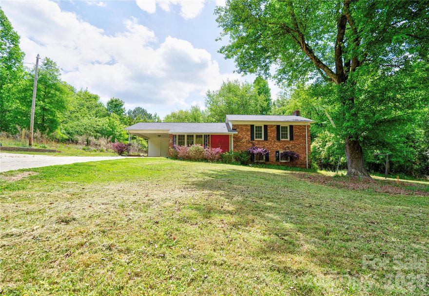 Spacious 3 Bedroom, 3 Bath brick split-level home offers room to spread out both inside and out! Situated on approximately 0.643 acres, this property features a large, partially shaded front and backyard—perfect for relaxing, entertaining, or play.  The main level includes a comfortable living room, dining area, and kitchen, creating a functional layout for everyday living. Upstairs, you’ll find three bedrooms and two full baths, including a private primary suite. The lower level adds even more versatility with a cozy family room featuring a classic brick fireplace, a full bath, laundry area, and a bonus room ideal for a home office, playroom, or additional living space.  Enjoy outdoor living from the covered front porch and take advantage of the single attached carport with storage room, extra parking pad, and an additional storage building for all your needs.  This home offers space, flexibility, and charm.  Don’t miss your opportunity to make it yours!