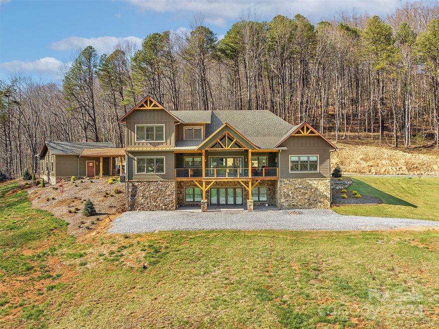 Perched on nearly 13 unrestricted acres just moments from Historic Main St Waynesville this extraordinary work of art was completed in Fall '23. Only the highest quality materials & expert level craftsmen retained to curate this dream home. Nearly every room boasts a view of the Blue Ridge Mountains. As you walk in the main floor you are immediately drawn outside to your covered outdoor living area overlooking the mountains & rolling pastures. Main floor includes expansive primary suite, laundry, kitchen/living area combination & formal dining. Upstairs is a loft, 2 more bedrooms and a Jack & Jill bath. The basement offers 2500+ of unfinished space. Expansive 2 car detached garage with portico.