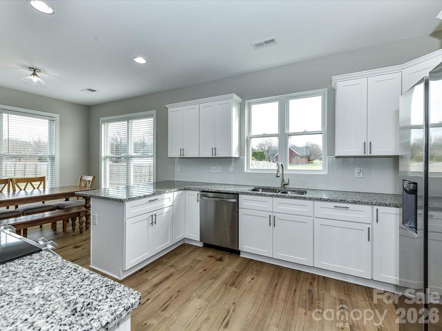 Are you looking for a like new home on over an acre with NO HOA literally only a few minutes from the 74 ByPass with easy access back to Monroe/Matthews or Charlotte? This could be it! Bring reasonable offers! Cozy front porch and large covered back porch extends the living space here for lots of entertaining, grilling and porch rocking. The huge back yard is wood fenced with privacy panels and so many possibilities for a pool, play set, gardening or building (no septic line to deal with!). The fence is just inside the property lines so even more space beyond to garden. Welcome inside this beautiful home to an open foyer/ floorplan and stairway overlooking greatroom. Primary bedroom on main level with beautiful primary bath including dual vanity, tiled walk-in shower, free standing tub, separate water closet and includes large walkin closet. Large Greatroom with grand ceilings and open to kitchen area. Kitchen offers an abundance of cabinets, granite tops, tiled back splash and stainless appliances.  Breakfast bar leads to Large dining area to accommodate a large table. Laundry Area on main level. Upstairs you will find a split bedroom plan with 2 bedrooms and a full bathroom. Extra Room up works perfect for bonus/play room or office space. A nice sized 2 car garage with storage room and longer paved driveway for more parking for guests. You will love the country living feeling with city amenities including water and sewer!! Come See and Fall in love with your new home!