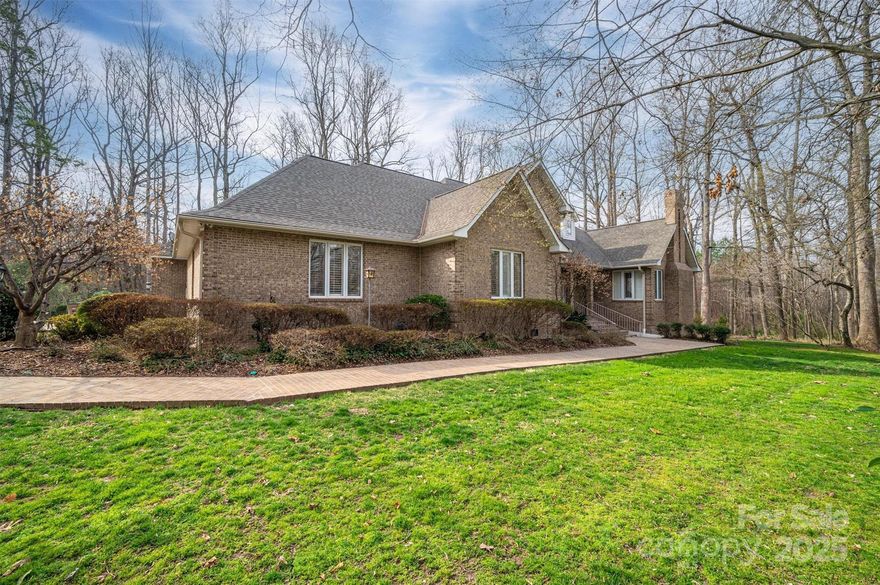 Freshly painted deck and interior! Roof and exterior pressure washed!  This home is located in Country Club Gardens on 2.91 acres!  Approach this home from the long private driveway.  The stunning garden has landscape lighting and water features.  Enjoy the oversized detached carport perfect for your RV.  The large kitchen features an open floor plan to the LR for easy entertaining.  Enter the formal dining room with wet bar for uninterrupted meals.  12+ FT ceilings on main.  Exit onto the expansive deck and find plenty of built-in seating, overlooking the serene woods. The primary BR is large and set back from other living areas for added privacy.  Enjoy the ensuite bathroom with three sinks, LED and fog proof mirrors, heated floors, plenty of closet space, soaking tub and a shower with additional shower heads for an immersive experience.  Upstairs features three BR's and two upgraded BA's with ornate hardware and tiling that is carried throughout the other bathrooms. Walkout basement with kitchen, den, bedroom, fireplace and storage.  Plenty of privacy for guests or live in housekeepers.