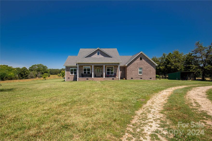 This beautiful, all-brick ranch-style home is located on 15 peaceful acres. The property is perfect for those looking for a mini-farm to call home. As soon as you step inside, you'll be greeted by a stunning, neutral color palette that's right on trend. The high ceilings in the living space create an open and airy atmosphere. The living space seamlessly flows into the breakfast area and the elegant white cabinetry of the kitchen. With granite countertops, stainless steel appliances, and a spacious work island, the kitchen is a joy to cook in. The primary suite is located in the back corner, offering plenty of privacy. On the opposite side of the home, you'll find two guest rooms, an office/study, and a flexible living space.