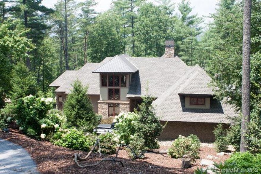 Awesome best describes this exquisite custom built home on 2.25 acre lot with 389' of waterfront on Lake James.  Main level features open area great room w/ stone FP & vaulted ceiling, dining area, kitchen, pantry & laundry room, study, master bdrm w/ vaulted ceiling & bath.  Screened porch w/ stone FP that adjoins separate guest quarters w/ bdrm & bath. Lower level has family rm, 2 bdrms with baths, wine cellar, workout rm & unfinished storage area.  Lakeside dock with boat slip. Large windows in most every room highlights the serenity of this natural setting.  Included is membership to Camp Lake James. Be sure to visit Camp Lake James online which has so many amenities for the entire family.