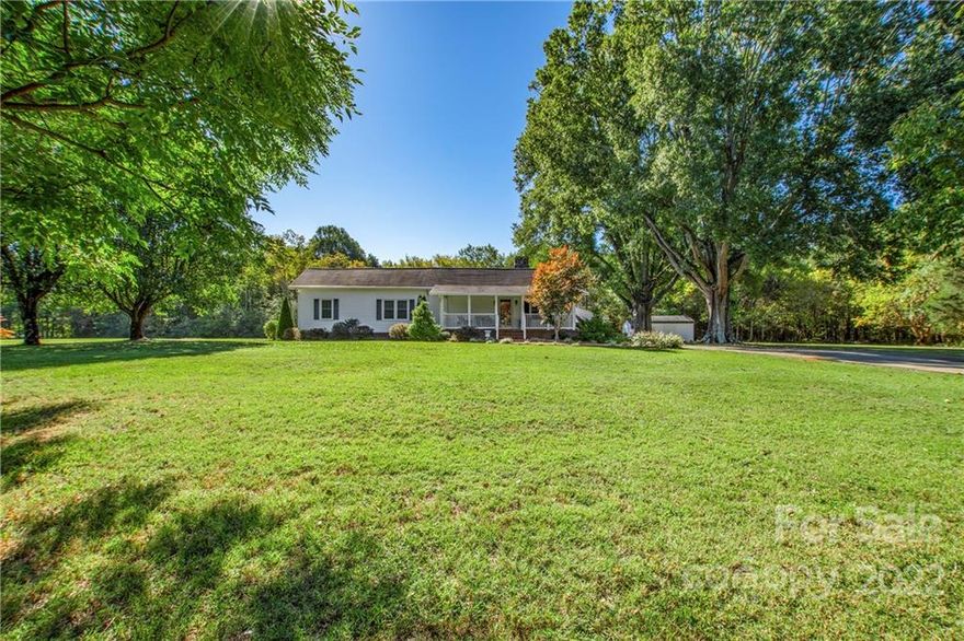 Charming and well maintained, this home is sure to impress! Enjoy the outdoors on the massive front porch, or relax inside in the spacious living areas. This home has two bedrooms and offers tons of space, including a bonus room with potential to become a third bedroom. Large, flat front and back yards, a carport, and two storage buildings set this house apart from others. The outdoor setting is gorgeous, expansive, and sits privately on a large lot. This house has more than meets the eye! **Seller is willing to sell this home with all furnishings included, or no furnishings included, or anywhere in between!
