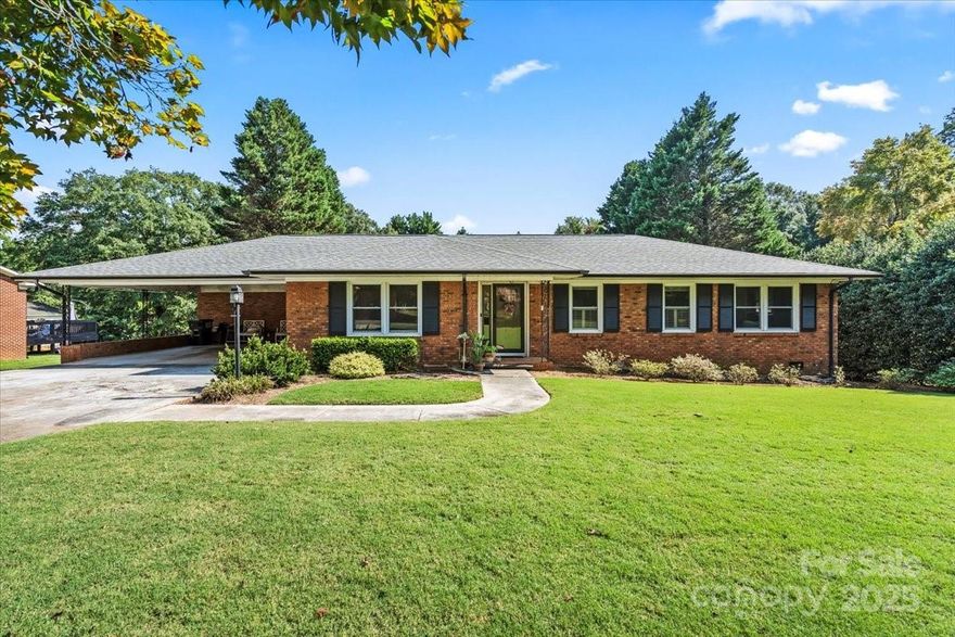 A rare opportunity! This charming brick ranch blends modern updates with classic comfort. No HOA or city taxes! Perfectly positioned on a spacious lot, this home offers the best of convenience and retreat. Enjoy a beautifully updated eat-in kitchen featuring a large island with built-in storage and plenty of space to gather. The home boasts 3 generously sized bedrooms and 2 full bathrooms, both tastefully updated. Abundant natural light fills the home, complemented by privacy shutters for comfort and style. Through the carport entrance, an oversized mud and utility room adds everyday functionality and extra space. The 2-car carport makes parking a breeze and the expansive backyard creates room to relax and entertain. The workshop/shed has electricity and is perfect for hobbies and storage. Location is unbeatable—just 2 miles from Downtown Belmont, less than a mile from grocery and dining options and minutes to parks and a boat launch for Lake Wylie adventures. You’ll enjoy quick access to I-85, making it a smooth 20-minute drive to Uptown and keeping you close to all major attractions while still offering a peaceful escape. Lovingly maintained and move-in ready, this home is the opportunity in Belmont to enjoy space, updates and convenience without compromise!