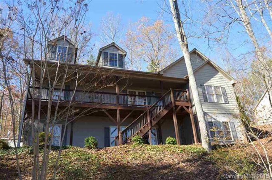 Attractive home offers benefits of true mountainside living, including expansive decks and scenic views, yet is within easy reach of city conveniences. With it's open-concept floor-plan, this home features a comfortable living room w/gas-log FP & vaulted ceiling, kitchen w/warm cabinetry, granite counter-tops, sep eating/preparation bar, and open dining area. Warm, easy to maintain, hdwd floors found throughout entire main level of home. Covered back deck overlooks backyard and is located off...