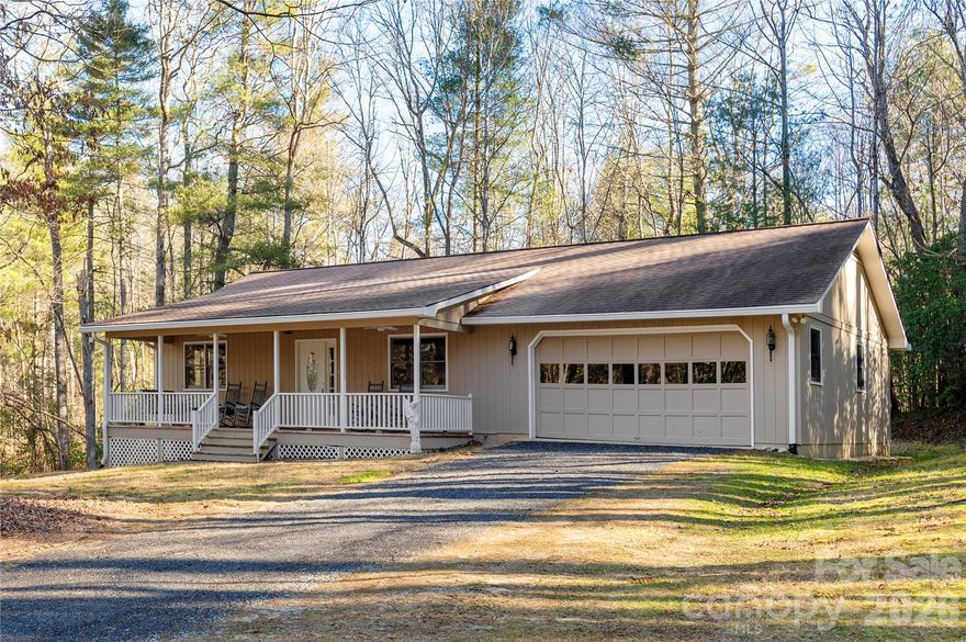 Lovely updated home on over 3 acres! This spacious 2-bedroom, 2-bath home features a beautifully updated kitchen, main-level garage, screened porch, and a charming rocking-chair front porch. The 3.17-acre wooded lot offers privacy and peaceful surroundings, plus workshop space for hobbies or storage.