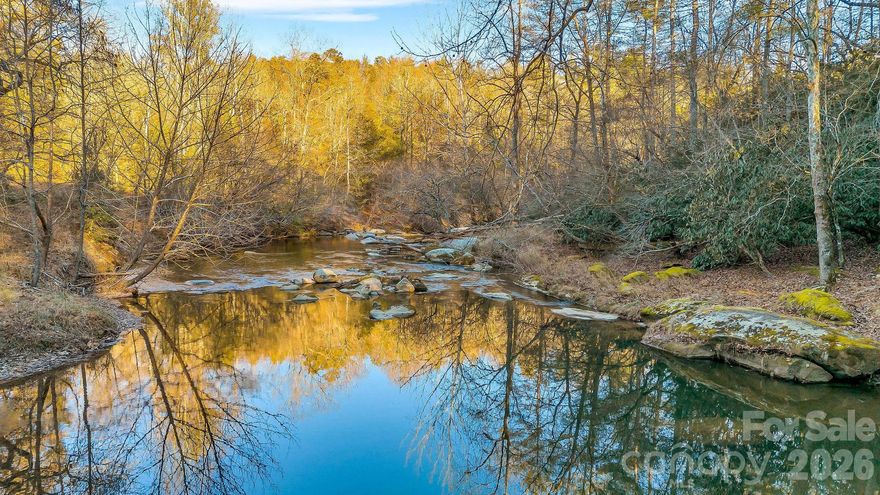 Tucked away on approximately 7.4 acres +/-with over 200 ft of river frontage, this secluded property offers privacy, comfort, and adventure within a gated community. The main home features 3 bedrooms and 2 bathrooms with fresh paint and new flooring on the main level, stainless steel appliances, accent walls, a dedicated laundry room, and a cozy wood burning fireplace. The primary suite includes an en suite bathroom with a garden tub, separate shower, and a large walk in closet. An oversized bonus room provides flexible space for a home office, playroom, or additional living area.

Enjoy outdoor living from the covered front porch or the back deck overlooking the fenced in yard, ideal for relaxing or entertaining. Also included on the same parcel is a charming 2 story river cabin with a 2 tier deck overlooking the river. The cabin may be used as a short term rental. Conveniently located near wineries, hiking trails, Stone Mountain, and more, this property offers peaceful seclusion close to outdoor and lifestyle amenities.