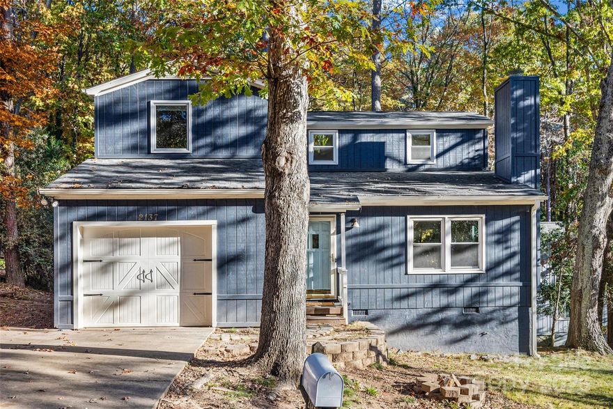Nestled in a wooded backdrop with peek-a-boo views of Lake Wylie, this well-maintained Tega Cay home is ready to be yours! A rare find with a 1 car garage and ample driveway parking space, you are welcomed in at the covered front porch. As you make your way into the open and light-filled floor plan, a vaulted great room greets you with wood flooring. A cozy stone fireplace centers the room, and the windows give tons of natural light. The kitchen boasts butcher block countertops, white cabinets, updated faucet, pantry space, and island for extra prep. The dining area opens to the back deck, which overlooks the private and wooded lot, and check out the views down to Lake Wylie! Rounding out the downstairs is the primary bedroom and full bathroom, with a walk-in tiled shower. Upstairs you'll find another 3 bedrooms and a full bathroom. Tons of updates done including HVAC new 2024, roof replaced 2016, and fresh and neutral paint throughout just done. This Tega Cay home has no HOA, & area amenities include 10+ parks, beach & lake access, trails, optional swim club/pool, golf, tennis, easy access to the elementary school (which is rated a 9 on greatschools.org), and low SC taxes - don't miss out on this opportunity!