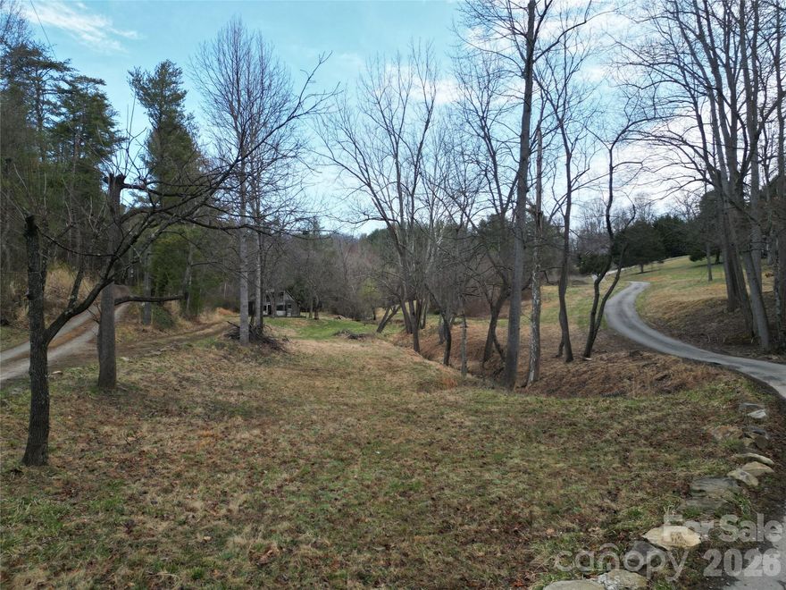 Rare opportunity to own a private, build-ready homesite in the beautiful Reems Creek Valley. This 1.4 acre parcel offers a level, cleared building site with an existing road already in place, making it an ideal turnkey opportunity for your future home. A three-bedroom septic permit is on file, and city water access is available. The property is quiet and private while still conveniently located near the Reems Creek Golf Course and just a short drive to Weaverville and Asheville. With no HOA, no restrictive covenants, and no minimum square footage requirements, this is a rare chance to build with flexibility in one of the area’s most desirable valleys. The adjacent parcel (approximately 2 acres) is also available for purchase, offering the opportunity to expand your footprint or secure additional privacy. Ask listing agent for details.