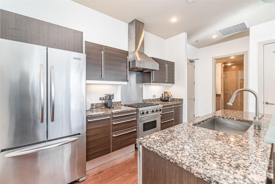 Exquisite Urban Oasis in The Metropolitan!  *Investment Opportunity*  Indulge in sophisticated city living with this stunning one-bedroom, one-bathroom condominium at The Metropolitan. This meticulously designed residence spans nearly 1,000 square feet of luxurious living space, featuring:

• Gleaming hardwood floors throughout
• Gourmet kitchen with Viking stainless steel appliances
• Sleek Pedini cabinetry and granite countertops
• Spa-like bathroom with tile flooring and frameless shower
• Soaring ceilings and abundant natural light
• Expansive private terrace with gas grill, perfect for al fresco entertaining

The open floor plan creates a seamless flow for modern living and entertaining. Residents enjoy the convenience of a secured parking space and direct access to premium shopping and dining, including Trader Joe's and Target. 
 Experience the pinnacle of urban luxury at The Metropolitan – where exceptional design meets unparalleled convenience.