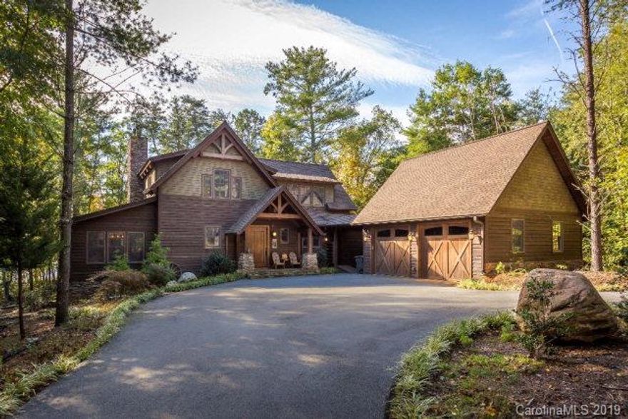 This timber frame Adirondack inspired home will make you want to spend all your free time at the lake. Beautiful exposed beam ceilings and a cozy stone fireplace grace the heart of the home. Enjoy cooking for the family in the well appointed kitchen with large island and commercial grade range. Large informal dining area is surrounded by windows to enjoy the woods. Small den with fireplace provides a quiet retreat. Master suite with fireplace, gracious bath, private office area and access to the covered, screened porch. Upstairs is features 3 bedrooms with built in beds under the eaves, a family/media room and 2 full baths. Full guest bed and bath and large mudroom/laundry also on main level. Wrap around screened porched and extensive decking/patio space provide entertaining and relaxing spaces. Level walk to private dock. Offered turnkey