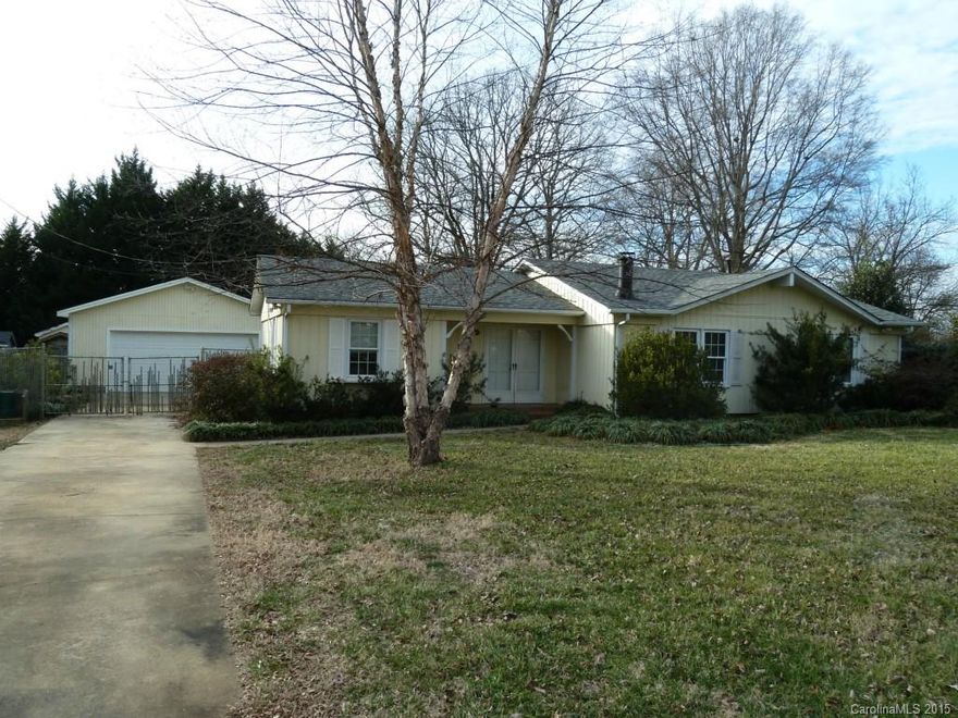 Over a half acre lot and convenient location in Downtown Mint Hill!  Needs lots of work but has potential for a nice home.  Stone  fireplace in living room, eat-in- kitchen, detached 2 car garage, vinyl windows and fenced yard.  Quiet street in Downtown Mint Hill, convenient to banking, shopping and I-485.